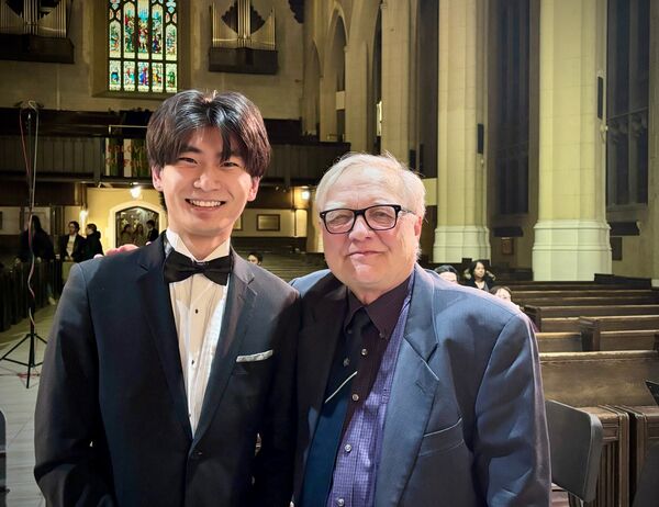 Ray Zheng and Maestro Uri Mayer pose for a photo after a University of Toronto Symphony Orchestra concert.