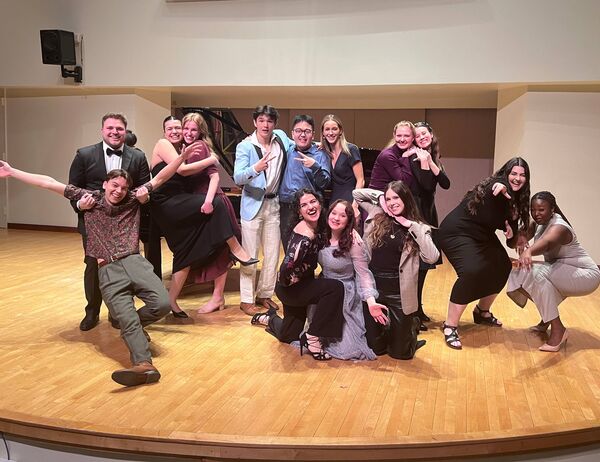 U of T Voice students, including Taline Yeremian, joyously pose for the camera following a performance in Walter Hall.