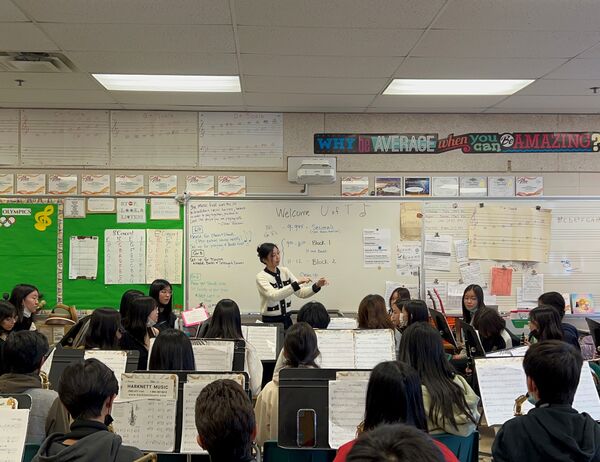 Tina Wang conducts a middle school band.