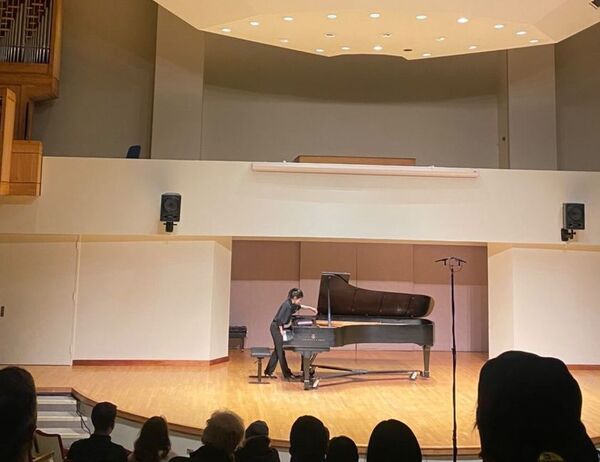 Yu-Pin Lai performs one a piece that utilizes extended techniques (prepared piano) in Walter Hall.