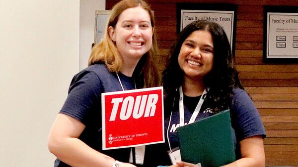 Thumbnail Image for Ambassadors holding a TOUR sign