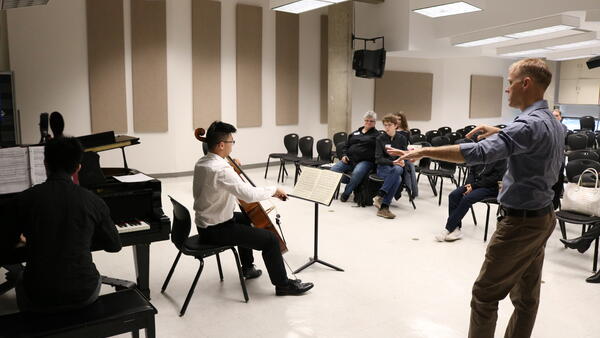 Thumbnail Image for Professor speaking to cellist at front of a master class