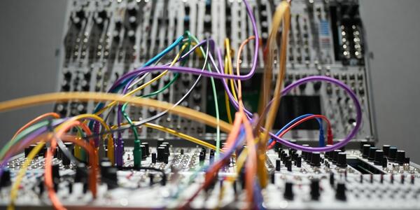 Electronic music equipment with colorful wires.