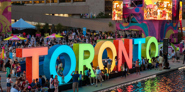 Large multi-colour marquee sign of Toronto in front of City Hall