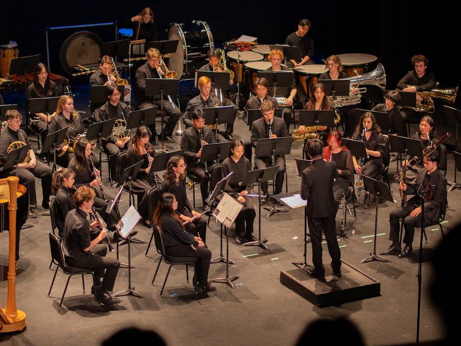 Wind symphony with a Student Conductor performing a piece