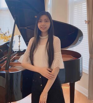 Tina Wang's headshot in front of a piano
