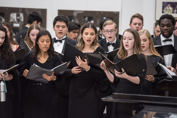 A group of young men and women singing