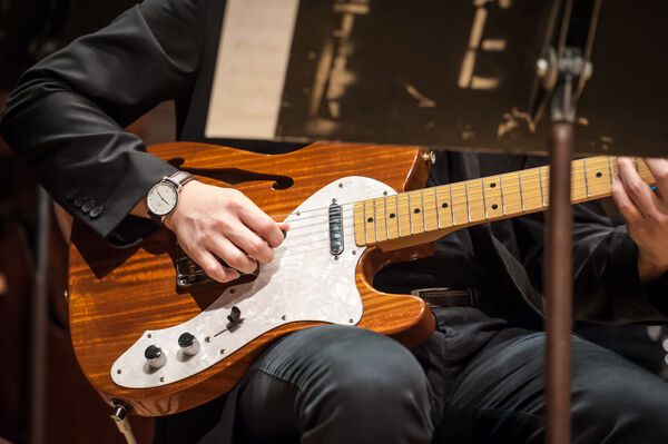 close-up of electric guitar being played