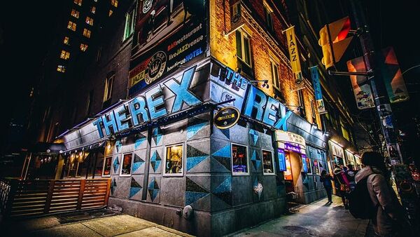 Front view of the Rex Jazz Club on Queen Street, with its inviting entrance and lively urban atmosphere.