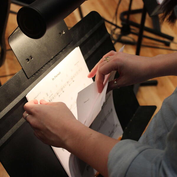 Reviewing sheet music on a stand