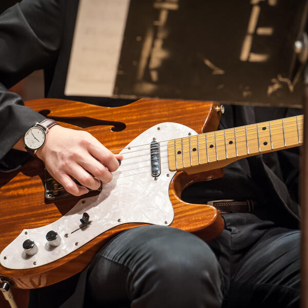 close-up of electric guitar being played